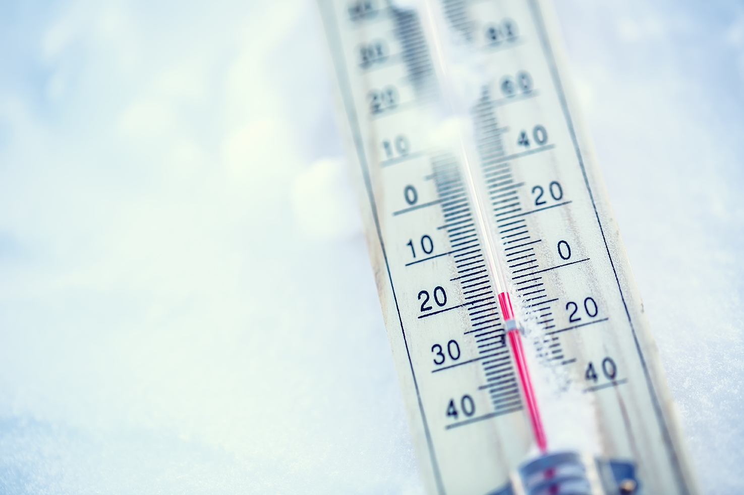 Thermometer reading cold temperature in snow.